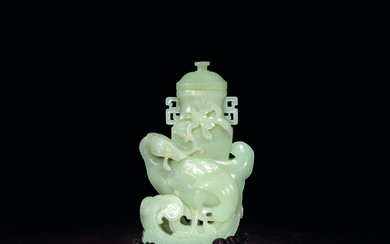 AN ARCHAISTIC WHITE JADE ‘MANDARIN DUCK AND LOTUS’ VASE AND COVER
