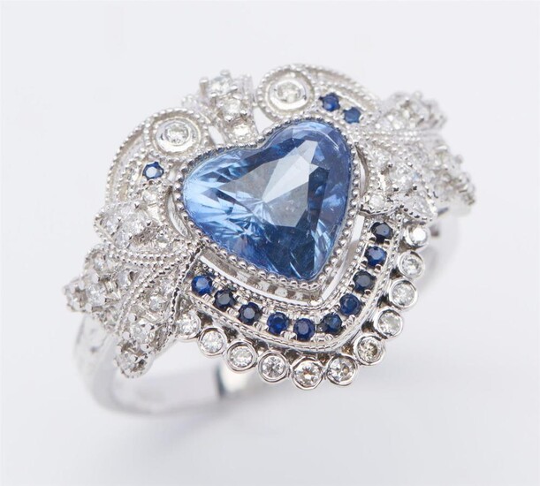 AN UNHEATED SAPPHIRE AND DIAMOND RING SET WITH A HEART SHAPED BLUE SAPPHIRE OF 2.49CTS, WITHIN A DECORATIVE SURROUND DETAILED WITH S...