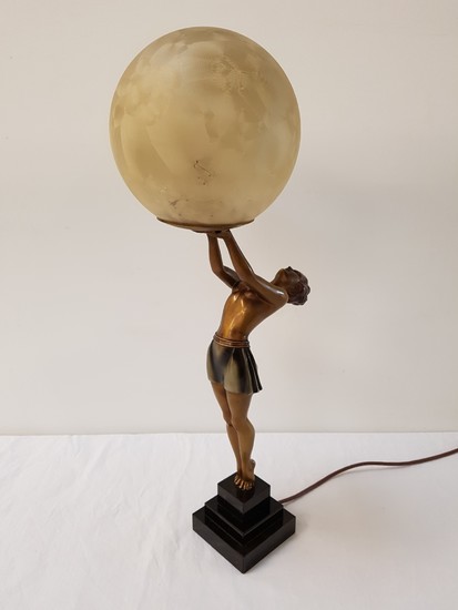 ART DECO SPELTER TABLE LAMP depicting a woman upright holdin...