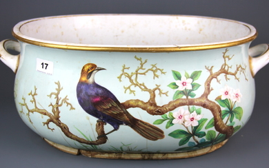 An 18th century gilt and hand painted porcelain foot bath with decoration of a bird amongst foliage, Dia. 43.5cm. (heavily repaired)