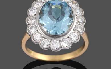 An Aquamarine and Diamond Cluster Ring, the oval cut aquamarine...