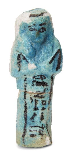 An Egyptian turquoise glazed composition shabti with black glazed details, holding two hoes, with a frontal column of hieroglyphic text, inscribed for Djed-Ptah-Iwf-ankh, wearing the seshed fillet and a seed-basket across the back, Third...