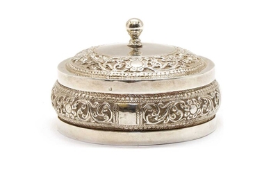 An Indian white metal jar and cover of squat circular form