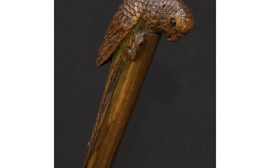 An early 20th century novelty walking stick, the handle carv...