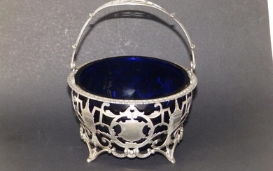 An openwork silver swing handled sugar basket, decorated neoclassical...