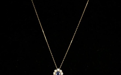 An oval sapphire and diamond 18ct gold halo pendant, the...
