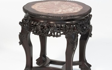 CHINESE ROSEWOOD STAND Top inset with rouge marble. Floral and figural-carved base. Height 18". Diameter 16.5".