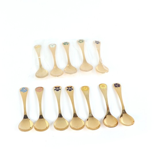 Collection of 12 gilt sterling silver annual spoons adorned with enamel. Georg Jensen. Weight 554 g. (12)