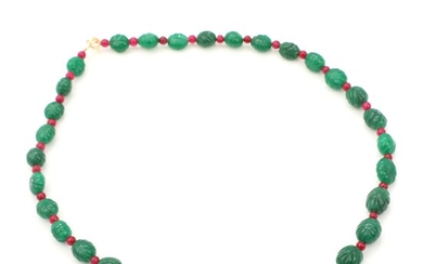 SOLD. Emerald necklace set with numerous carved emerald beads and red gemstones, 14k gold clasp....