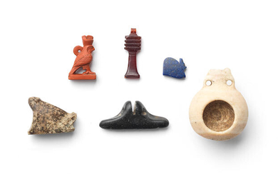 Four Egyptian hardstone amulets and a miniature alabaster pilgrim flask