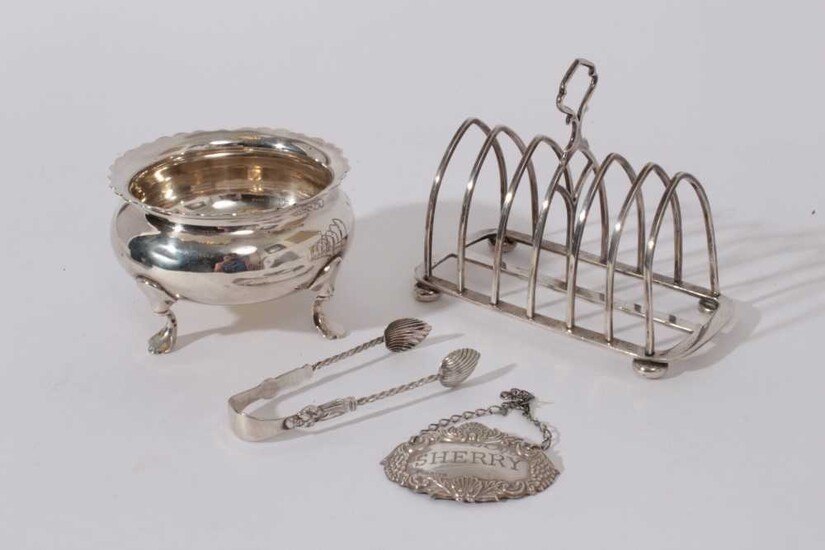 George V Silver six division toast rack (Birmingham 1919) together with a silver sugar bowl raised on four hoof feet (London 1922), late Victorian silver sugar tongs (Birmingham 1901)