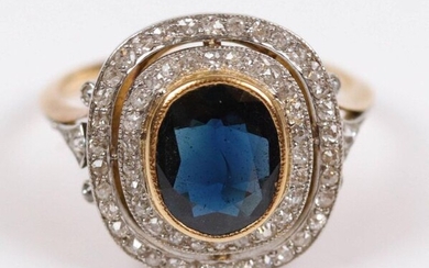 Gold ring (750) set with a blue stone surrounded by small brilliants. T: 56, Gross weight: 4.9 gr.