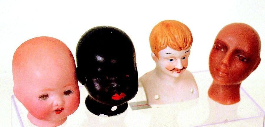 Group of poured bisque small doll heads including...