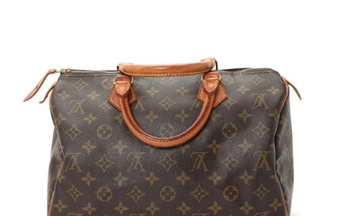 NOT SOLD. Louis Vuitton: A "Speedy 30" bag made of brown monogram canvas with brown...