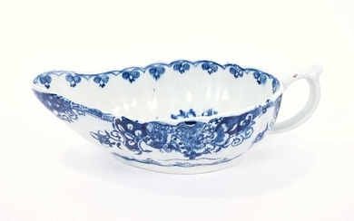 Lowestoft sauceboat, of flat bottomed form with reeded sides, the interior printed in blue with a 'doughnut' tree, an elaborate painted border to the outside, 22cm long