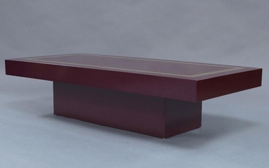 Manner of Willy Rizzo, a lacquered low table, circa 1970, the rectangular top inset with gilt metal trim, on conforming plinth base, 31.5cm high, 130cm wide, 60cm deep