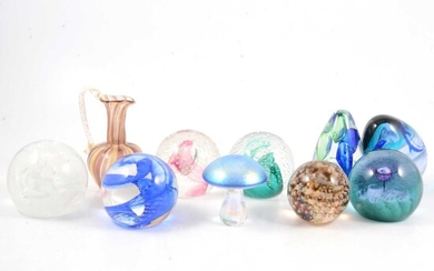 Nine Caithness and other glass paperweights, and a Murano glass vase.