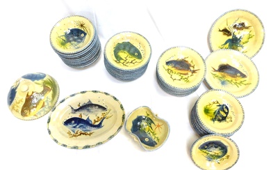Partie de service de vaisselle en céramique à décor émaillé de poissons et fond marin,...