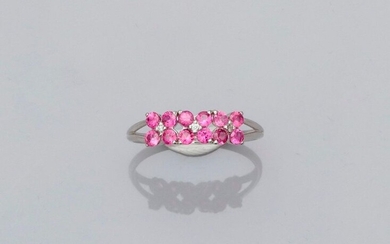 Ring in white gold, 750 MM, motif covered with round rubies interspersed with three diamonds, size: 53, weight: 1.8gr. rough.