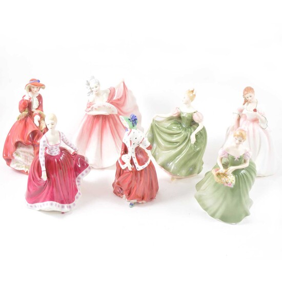 Seven Royal Doulton figurines.