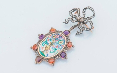Silver brooch (800 thousandths) adorned with a ribboned bow set with rose-cut diamonds, holding a pendant adorned with a miniature enamelled flower vase in a surround of square-shaped violet stones and oval-shaped orange stones.