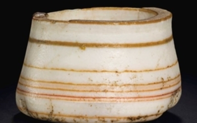 AN EGYPTIAN OR WESTERN ASIATIC BANDED STONE COSMETIC JAR, CIRCA LATE 3RD MILLENNIUM B.C.