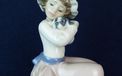 Nao figurine of a seated girl holding a puppy 7 inches tall. Excellent condition.