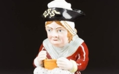 A PORCELAIN DECANTER IN THE FOR OF A SEATED WOMAN