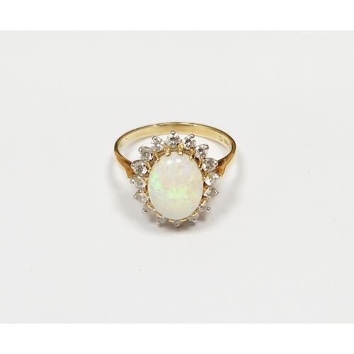 18ct gold, opal and diamond cluster ring, the oval opal surr...