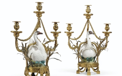 A PAIR OF FRENCH ORMOLU-MOUNTED MEISSEN PORCELAIN THREE-LIGHT CANDELABRA, THE PORCELAIN POSSIBLY MID-18TH CENTURY, TRACES OF BLUE CROSSED SWORDS MARKS TO THE BACK OF ONE, THE DECORATION OF A LATER DATE, THE ORMOLU 19TH CENTURY