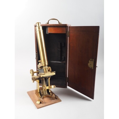 A 19th century brass monocular microscope with two lenses, i...