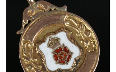 A 9ct gold fob with enamel Lancashire Rose crest inscribed f...