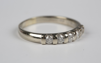 A 9ct white gold and diamond five stone ring, mounted with a row of circular cut diamonds, detailed