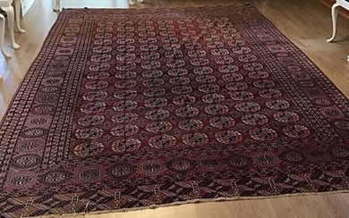 A Bochara carpet, Turkmenia. All over design on a red field. C. 1930–1950. 3.35×2.5 m.