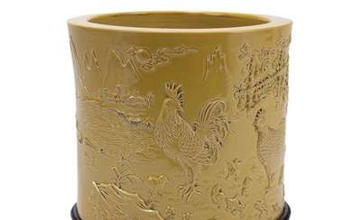 A CHINESE CARVED YELLOW GLAZED PORCELAIN BRUSH POT
