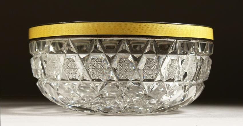 A CUT GLASS CIRCULAR BOWL with silver and yellow enamel