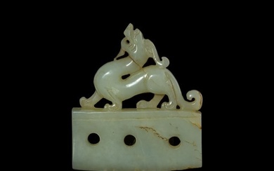 A Chinese carved white jade ax-form plaque with a beast-formed top, Ming dynasty