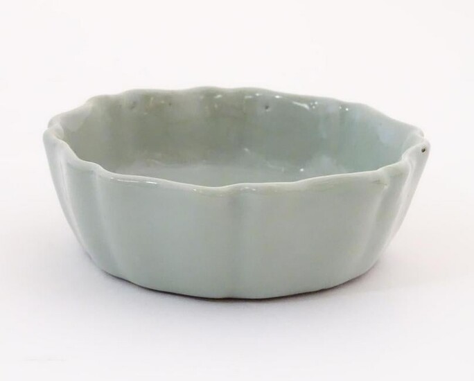 A Chinese celadon brush wash pot with a scalloped edge.