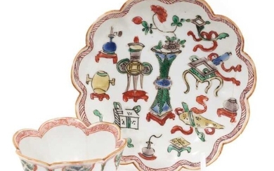 A Chinese famille verte tea bowl and saucer, Kangxi period, decorated with precious objects and auspicious symbols, marked to bases