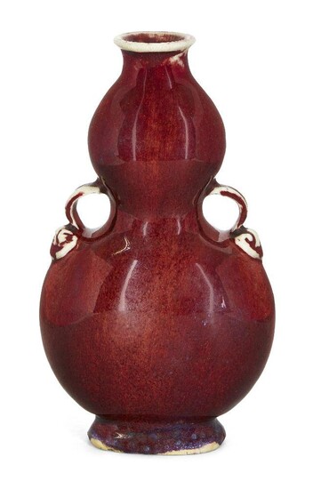A Chinese monochrome porcelain copper-red double-gourd vase, huluping, 19th century, of flattened form with moulded loop handles, 18.3cm high