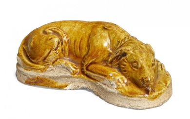 A Chinese pottery amber glazed dog, Tang dynasty, modelled in...