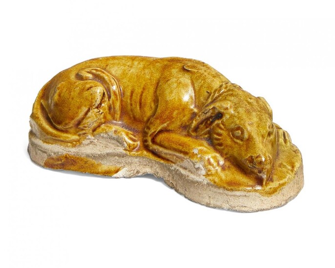 A Chinese pottery amber glazed dog, Tang dynasty, modelled in...