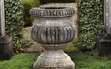 A Continental carved stone garden urn