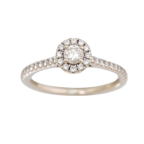 A DIAMOND HALO CLUSTER RING, the centre diamond to a diamond...