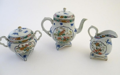 A Japanese teapot, twin handled sugar bowl and milk jug