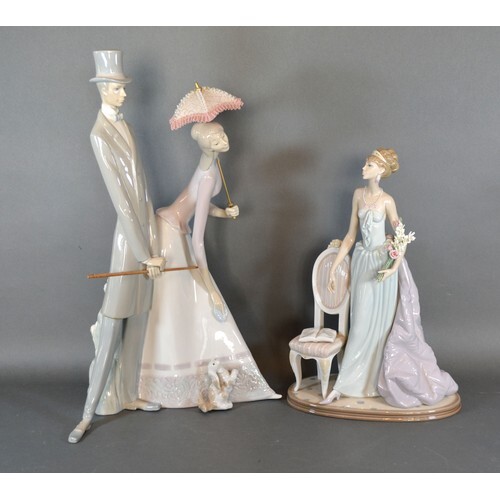A Lladro Porcelain Model in the form of a Girl Standing By A...