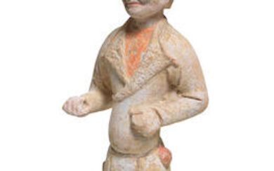 A PAINTED POTTERY FIGURE OF A FOREIGN GROOM