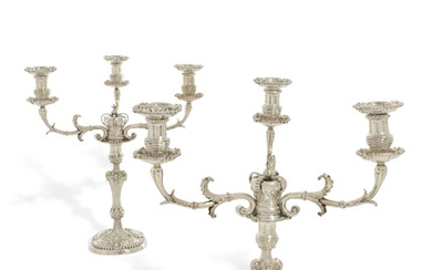 A PAIR OF GEORGE III SILVER THREE-LIGHT CANDELABRA, LONDON, THE CANDLESTICKS WITH MARK OF JOHN MEWBURN, 1811, THE CANDELABRA BRANCH SOCKETS AND NOZZLES WITH MAKER'S MARK TD, PROBABLY FOR THOMAS DANIELL, LONDON, 1807