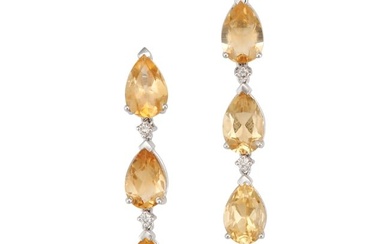 A PAIR OF YELLOW TOPAZ AND DIAMOND EARRINGS each set with a row of pear cut yellow topaz, accented