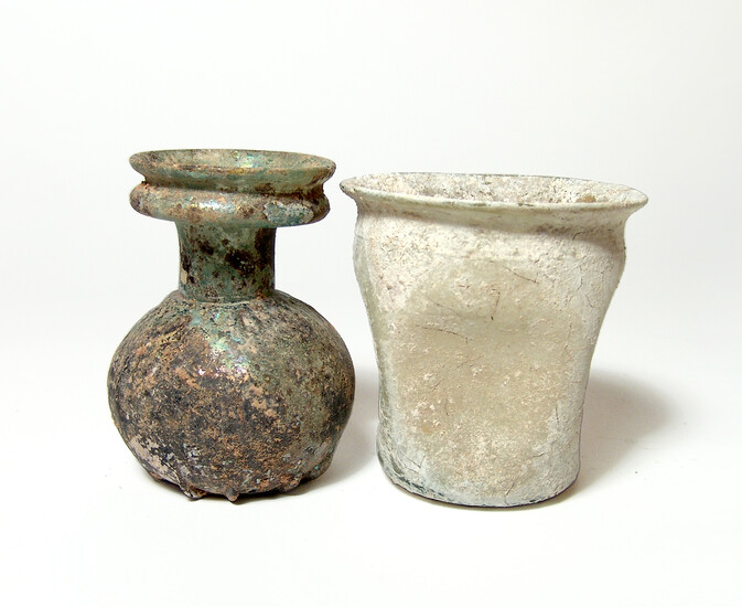 A Roman glass sprinkler bottle and an indented cup